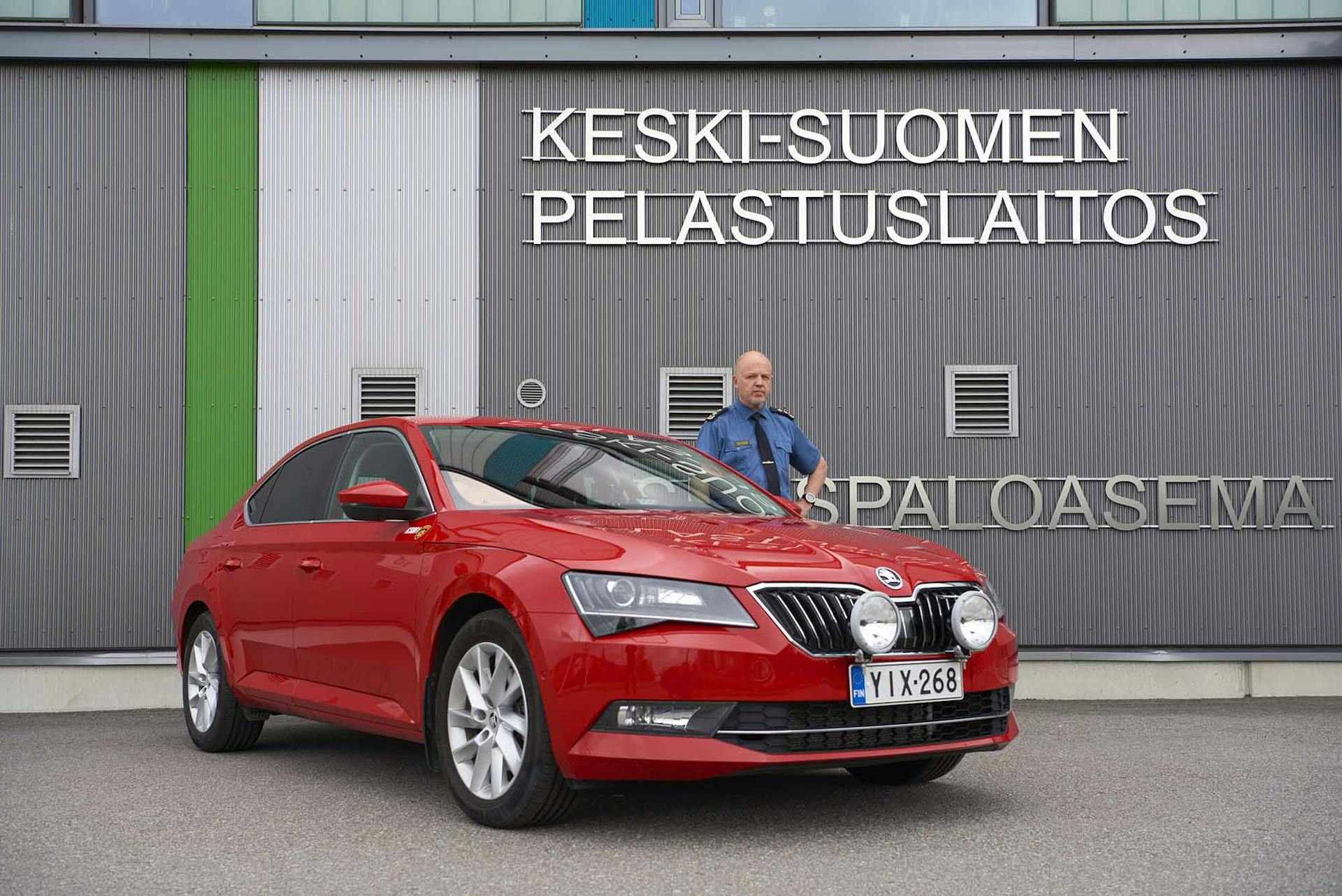 Palokunnanpunainen ŠKODA Superb 2.0 TDI 4x4 DSG Autom. erottuu liikenteestä. Simo Tarvainen on menopeliinsä tyytyväinen.